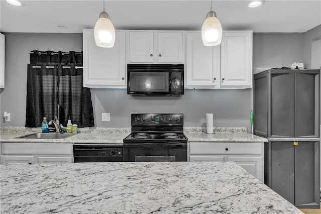 kitchen with white cabinetry, pendant lighting, and black appliances