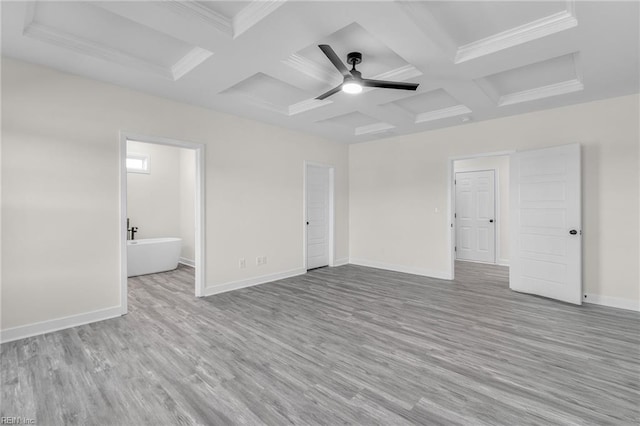 empty room with ornamental molding, coffered ceiling, ceiling fan, beam ceiling, and light hardwood / wood-style flooring