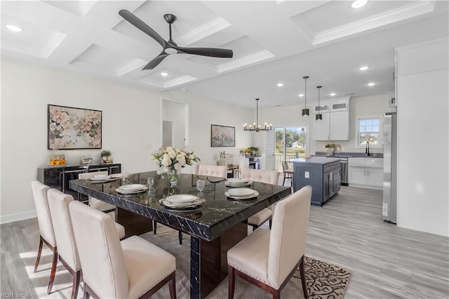 dining room with light wood-type flooring, coffered ceiling, ceiling fan with notable chandelier, crown molding, and beam ceiling