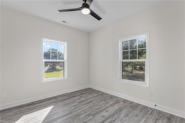 unfurnished room with light wood-type flooring and ceiling fan