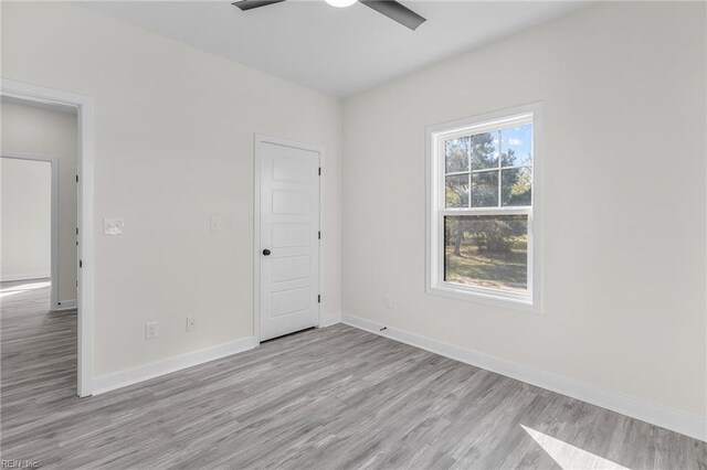 spare room featuring light hardwood / wood-style floors and ceiling fan