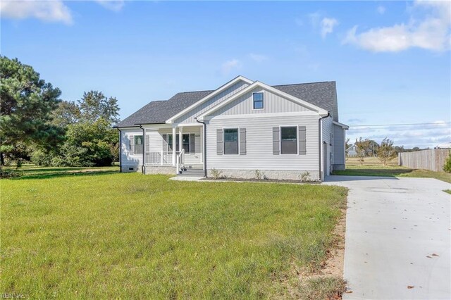 view of front of house with a porch, a garage, and a front yard