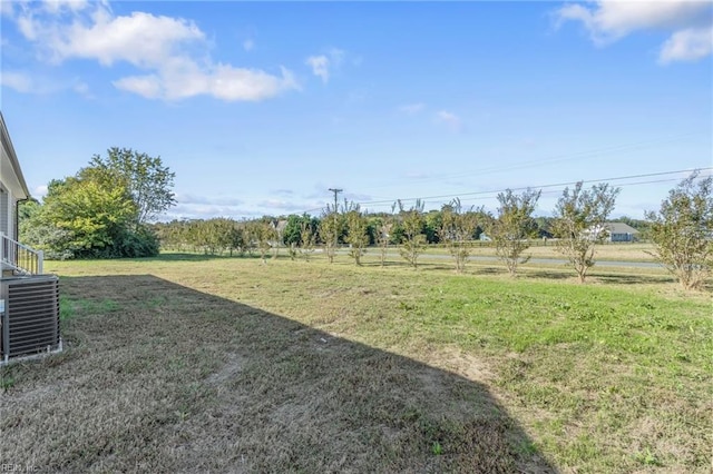 view of yard with a rural view and central AC unit