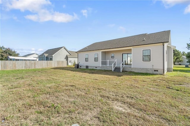 rear view of property with a yard