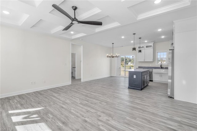 unfurnished living room featuring coffered ceiling, ceiling fan with notable chandelier, crown molding, and light hardwood / wood-style flooring