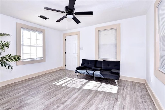 living area featuring ceiling fan and light hardwood / wood-style flooring