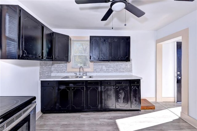 kitchen featuring ceiling fan, sink, light hardwood / wood-style flooring, backsplash, and stainless steel electric stove