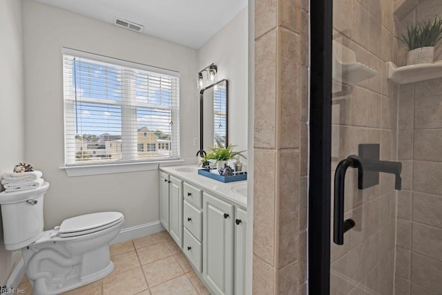 bathroom featuring tile patterned flooring, vanity, and toilet