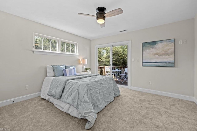 carpeted bedroom featuring access to exterior and ceiling fan