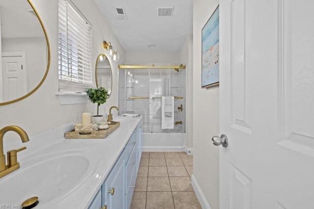 bathroom with tile patterned flooring, vanity, and combined bath / shower with glass door