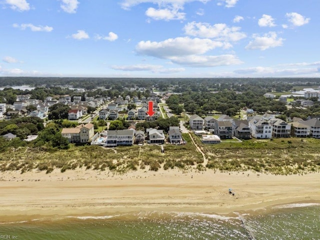 birds eye view of property with a view of the beach and a water view