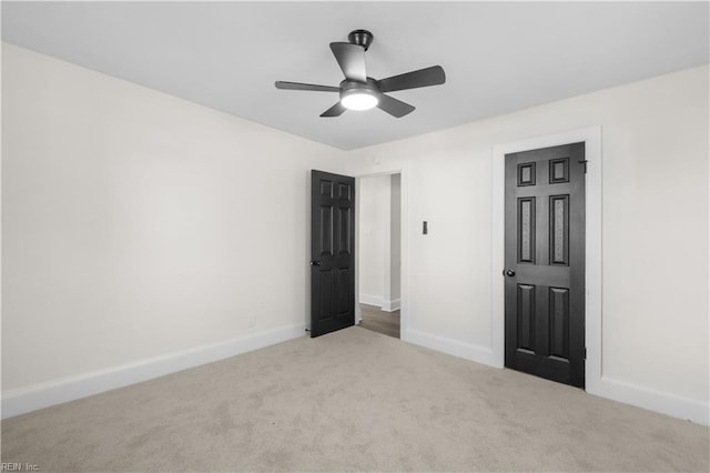 unfurnished bedroom featuring light carpet and ceiling fan