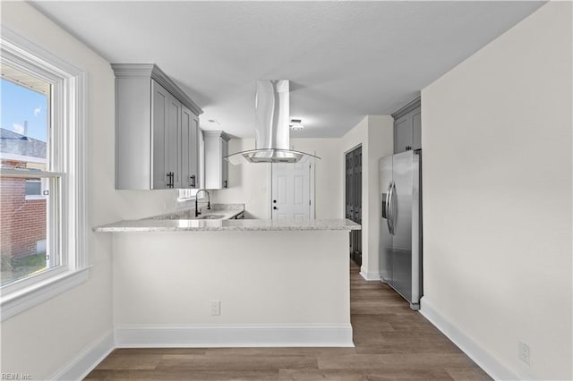 kitchen with stainless steel fridge, plenty of natural light, and gray cabinetry