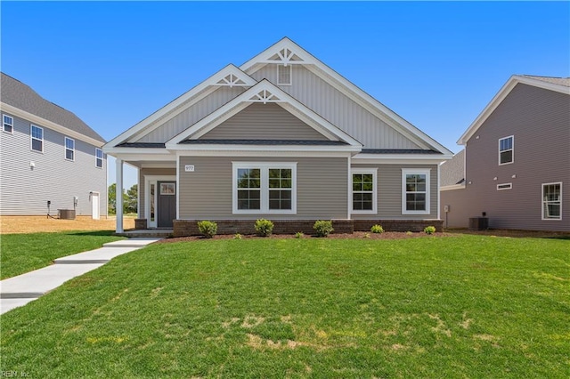 craftsman-style house with a front lawn and central air condition unit