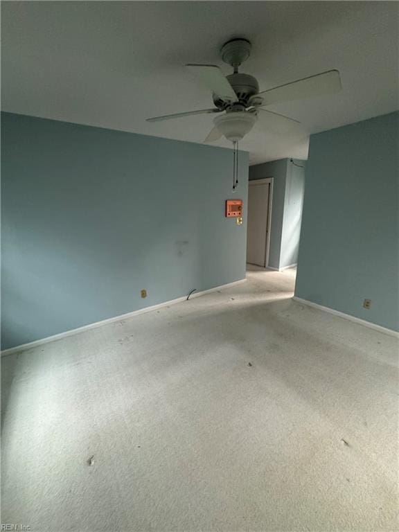 empty room featuring ceiling fan and light colored carpet