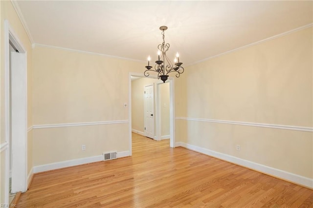 unfurnished dining area featuring hardwood / wood-style floors, a notable chandelier, and ornamental molding