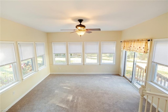 unfurnished sunroom featuring ceiling fan and lofted ceiling