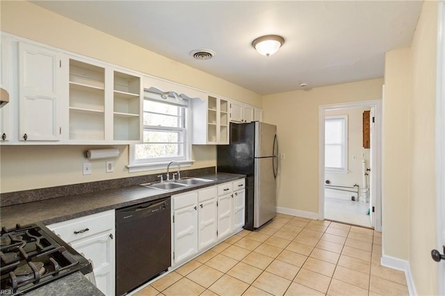 kitchen with white cabinets, sink, light tile patterned flooring, and black appliances