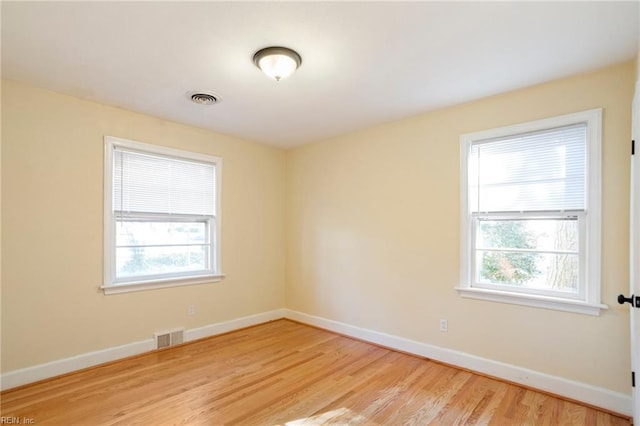 spare room featuring light hardwood / wood-style flooring