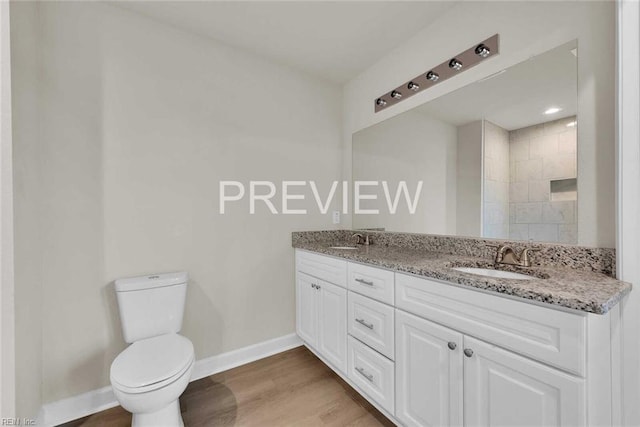 bathroom with vanity, hardwood / wood-style flooring, and toilet