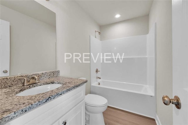 full bathroom featuring hardwood / wood-style floors, vanity, shower / bath combination, and toilet