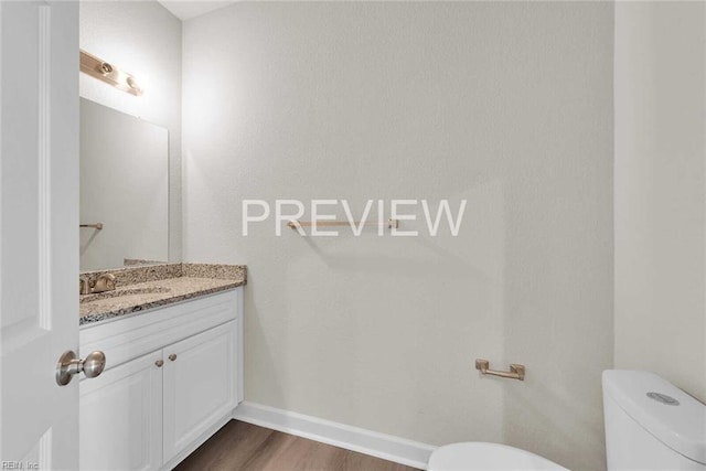 bathroom featuring vanity, toilet, and wood-type flooring