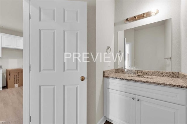 bathroom with hardwood / wood-style flooring and vanity