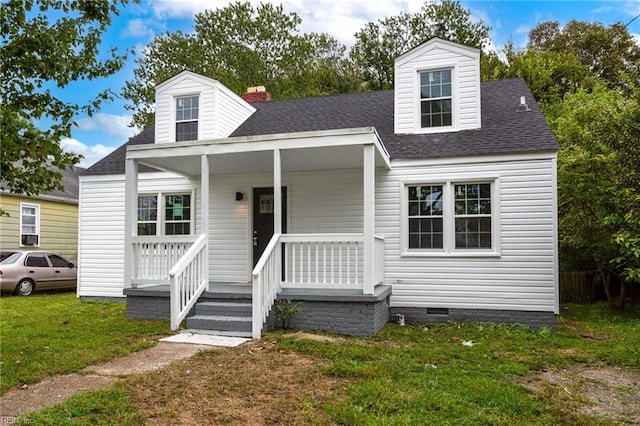 new england style home with covered porch and a front lawn