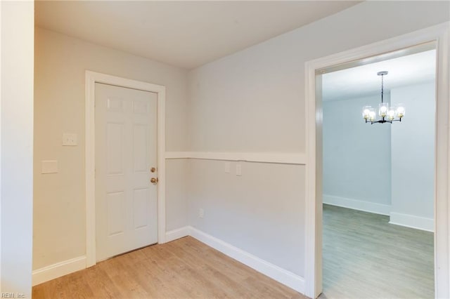 interior space featuring hardwood / wood-style floors and an inviting chandelier