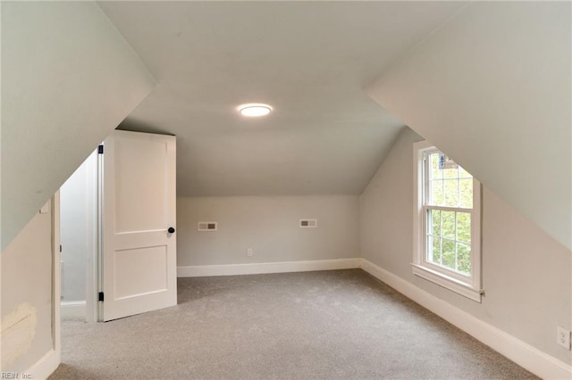 bonus room featuring light colored carpet and lofted ceiling