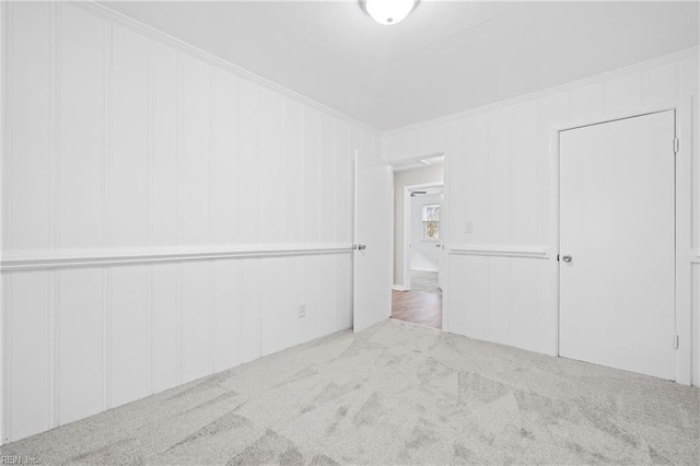 carpeted spare room with ornamental molding