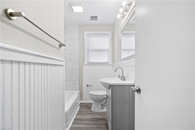 full bathroom featuring bathtub / shower combination, wood-type flooring, vanity, and toilet