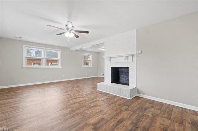 unfurnished living room with dark hardwood / wood-style floors, ceiling fan, and a fireplace