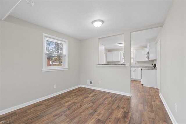 unfurnished room with dark hardwood / wood-style floors