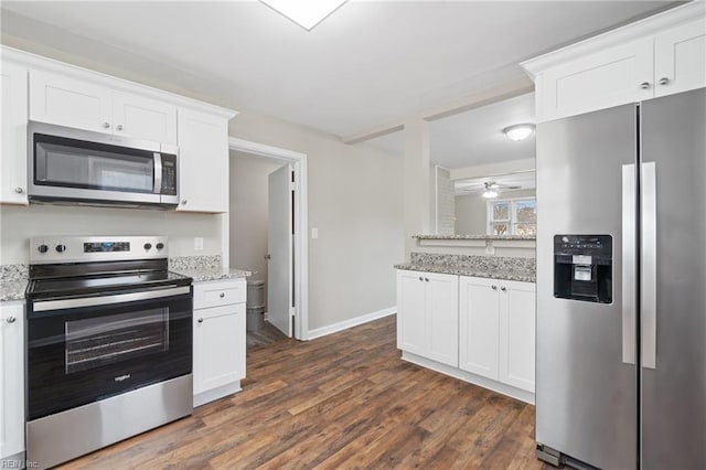 kitchen featuring light stone countertops, ceiling fan, stainless steel appliances, dark hardwood / wood-style flooring, and white cabinets