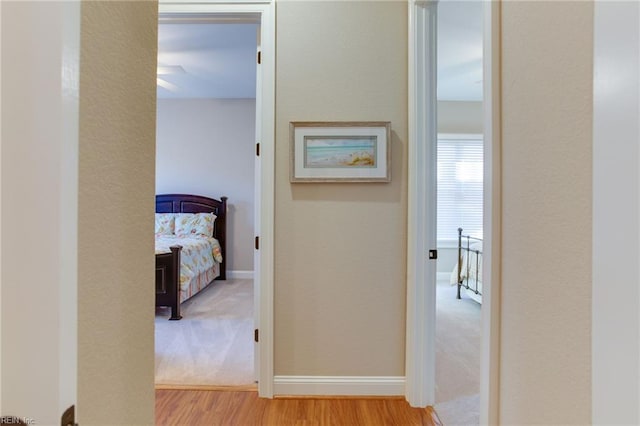 corridor with light hardwood / wood-style flooring