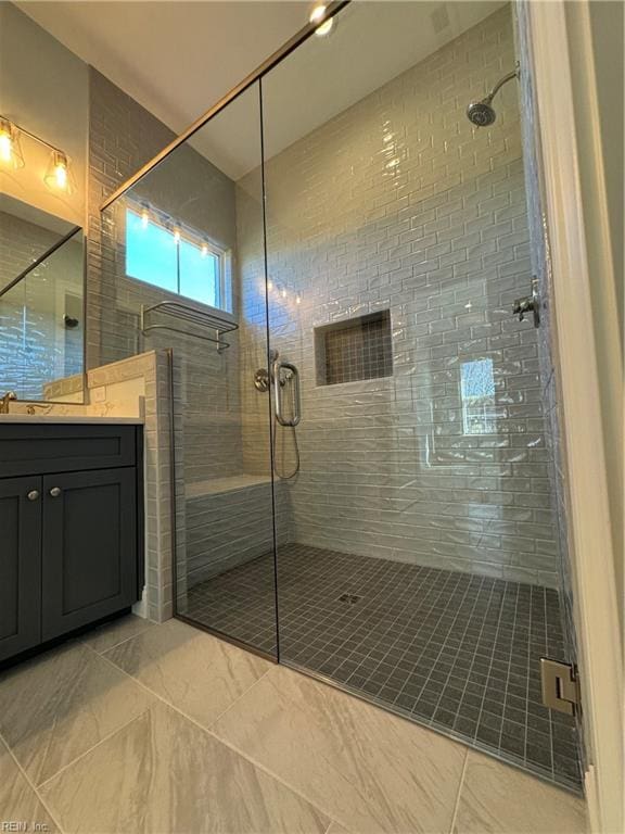 bathroom featuring vanity and a shower with shower door