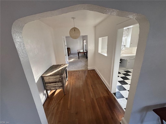 corridor with dark hardwood / wood-style flooring