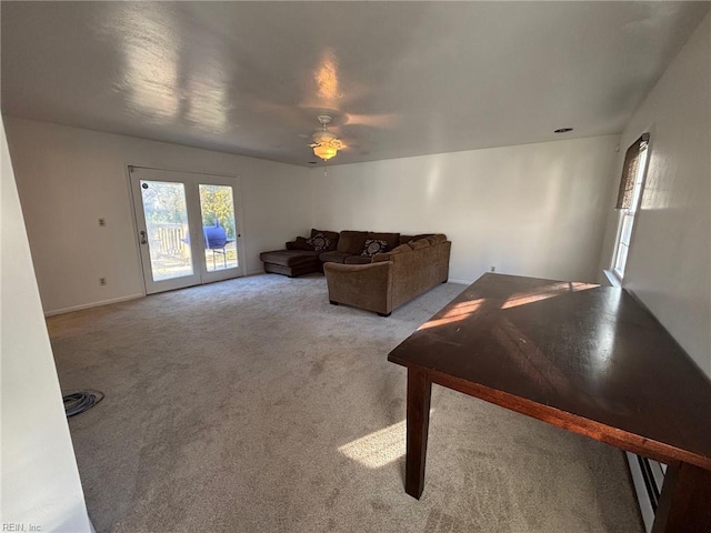 carpeted living room featuring ceiling fan