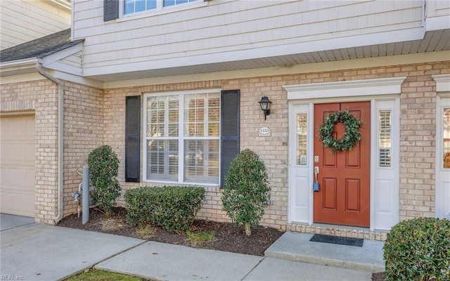 view of exterior entry featuring a garage