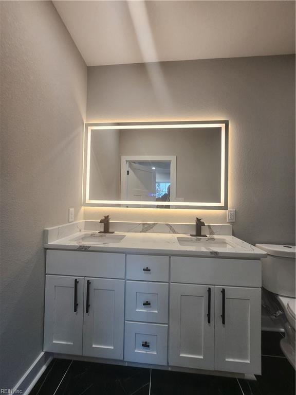 bathroom with tile patterned floors, vanity, and toilet