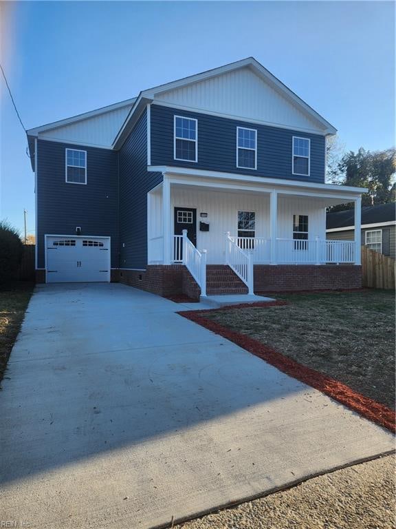 view of front of property with covered porch and a garage