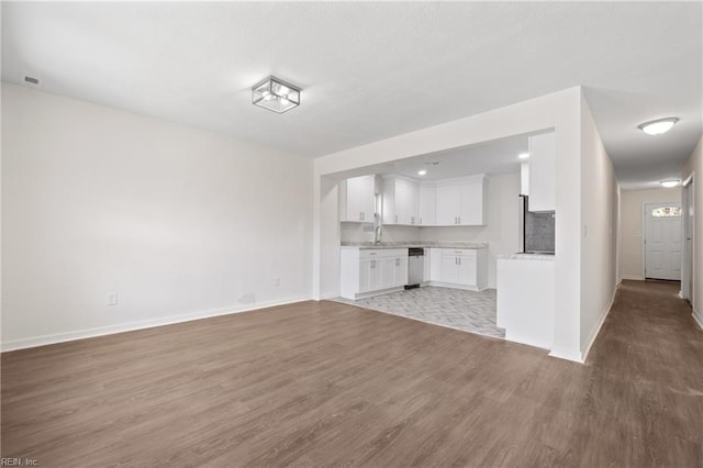 unfurnished living room featuring light hardwood / wood-style floors and sink