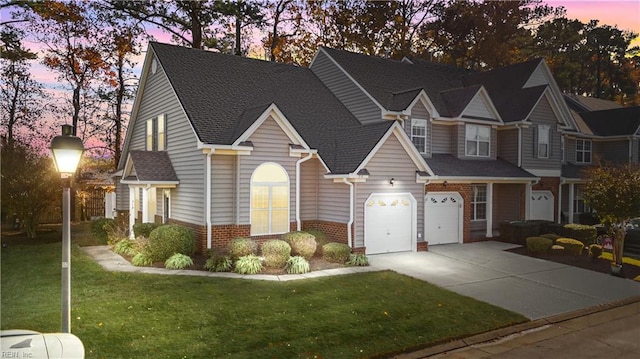 view of front of home featuring a garage and a yard