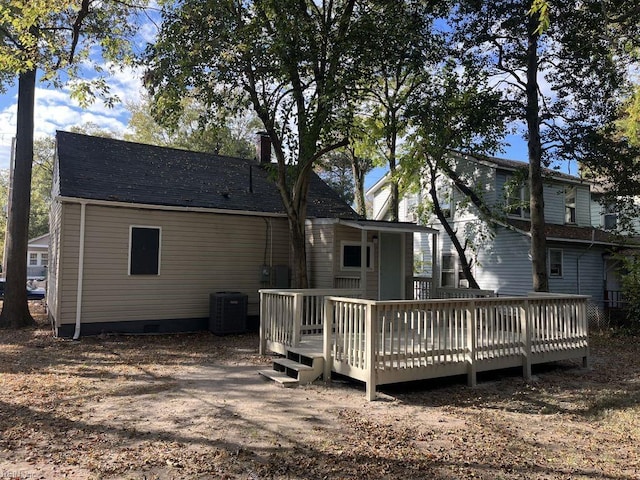 rear view of house with central air condition unit and a wooden deck