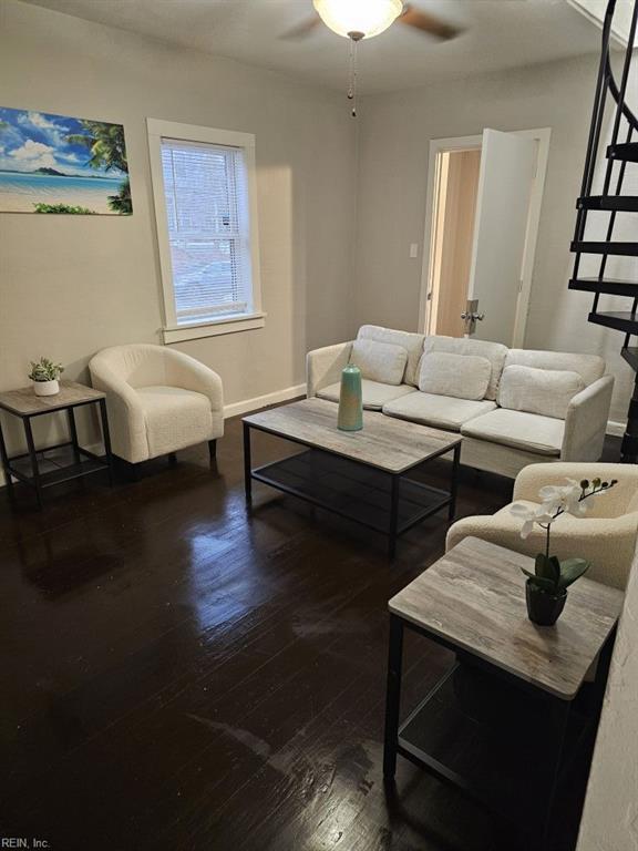 living room with ceiling fan and dark hardwood / wood-style floors