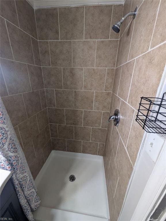 bathroom with tiled shower