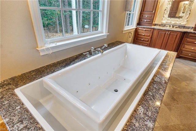 bathroom with vanity, tile patterned floors, and a bathing tub