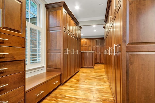 hallway featuring light hardwood / wood-style flooring and ornamental molding