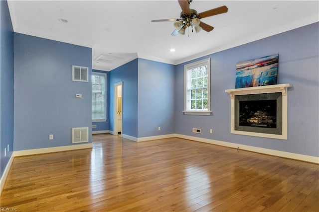 empty room featuring crown molding, light hardwood / wood-style flooring, and ceiling fan